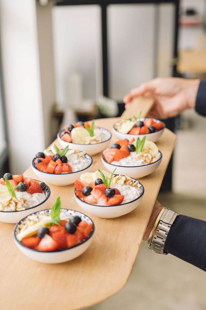 services-02 A serving of vibrant fruit-topped bowls on a wooden tray, perfect for a healthy breakfast.